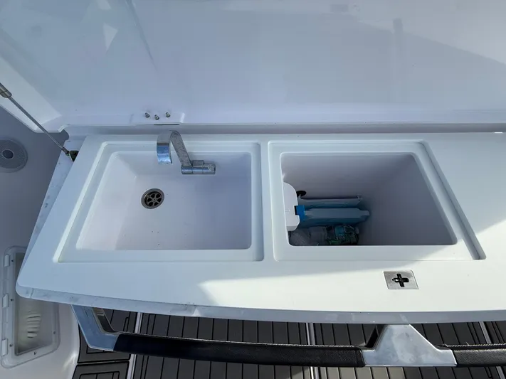  Yacht Photos Pics 2023 Axopar 37 Cross Cabin sink and storage area on deck.
