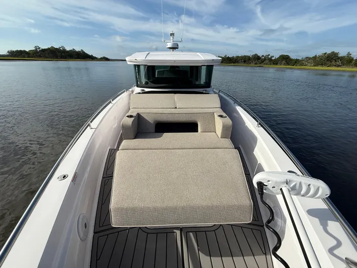  Yacht Photos Pics 2023 Axopar 37 Cross Cabin boat with spacious deck and seating on calm water.