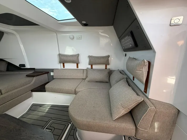  Yacht Photos Pics 2023 Axopar 37 Cross Cabin interior with modern seating and skylight.