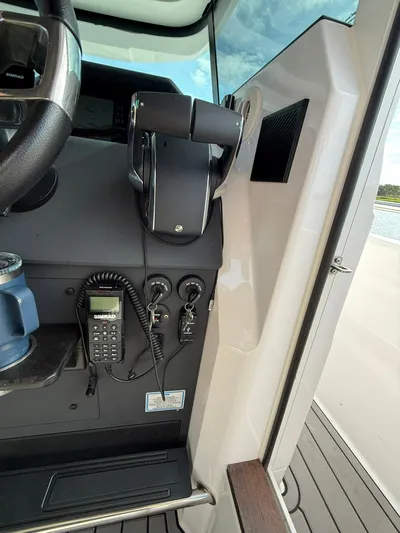  Yacht Photos Pics Control panel of 2023 Axopar 37 Cross Cabin with steering wheel and communication device.