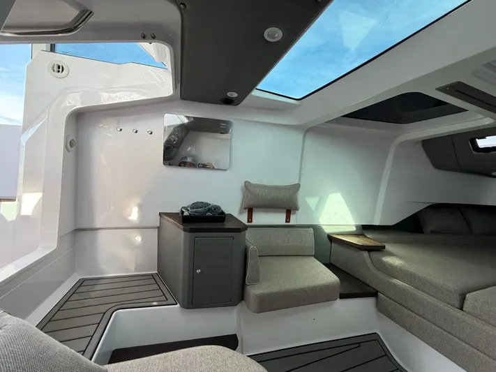  Yacht Photos Pics 2023 Axopar 37 Cross Cabin interior with modern seating and skylight.