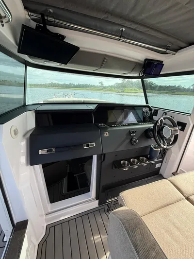  Yacht Photos Pics Interior of 2023 Axopar 37 Cross Cabin boat with modern dashboard and steering wheel.