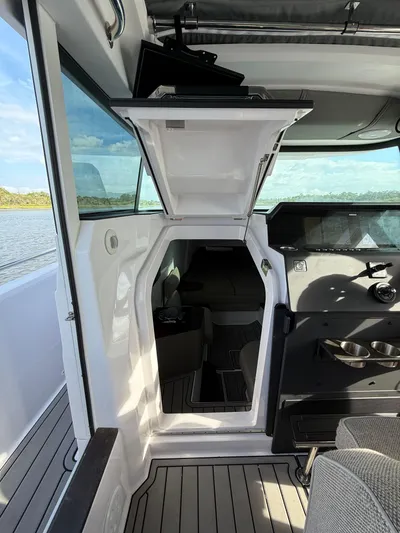  Yacht Photos Pics 2023 Axopar 37 Cross Cabin interior with open hatch, showcasing sleek design and modern features.