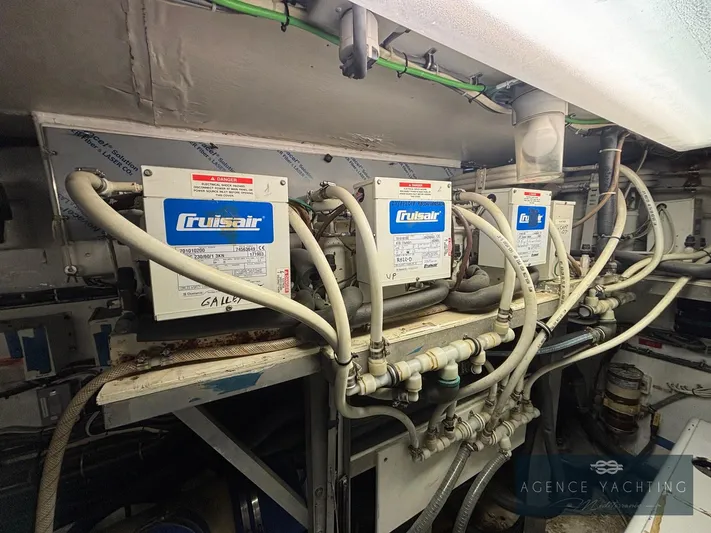  Yacht Photos Pics Engine room of 1987 Hatteras 85 yacht with Cruisair units and piping.