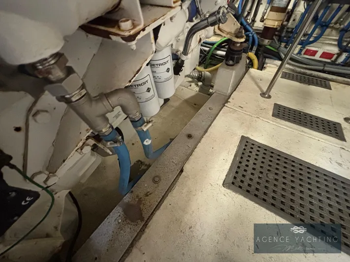  Yacht Photos Pics Engine room of 1987 Hatteras 85 yacht, showing pipes and filters.