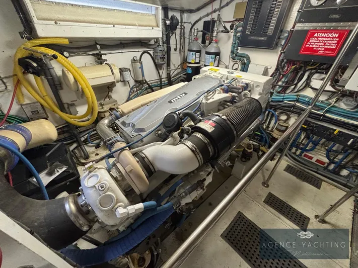  Yacht Photos Pics Engine room of a 1987 Hatteras 85 yacht, showcasing detailed mechanical components.