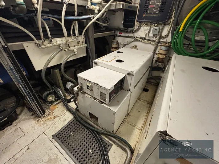  Yacht Photos Pics Engine room of 1987 Hatteras 85 yacht with machinery and cables.