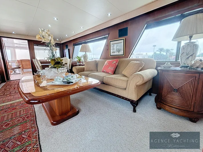  Yacht Photos Pics Luxurious interior of 1987 Hatteras 85 yacht with elegant furnishings and large windows.