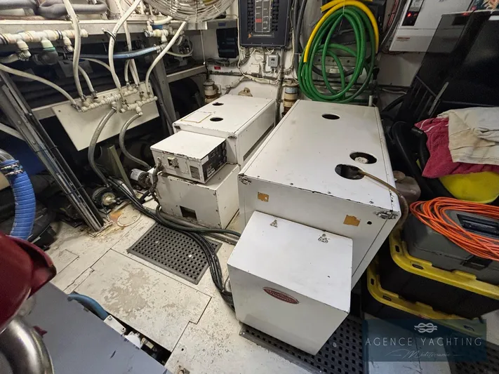  Yacht Photos Pics Engine room of a 1987 Hatteras 85 yacht with equipment and hoses.