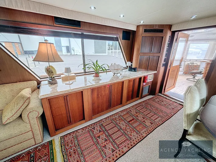  Yacht Photos Pics Luxurious interior of a 1987 Hatteras 85 yacht with elegant wood paneling.