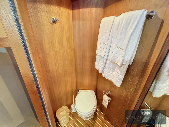  Yacht Photos Pics Luxurious wooden bathroom on 1987 Hatteras 85 yacht with towels and toilet.