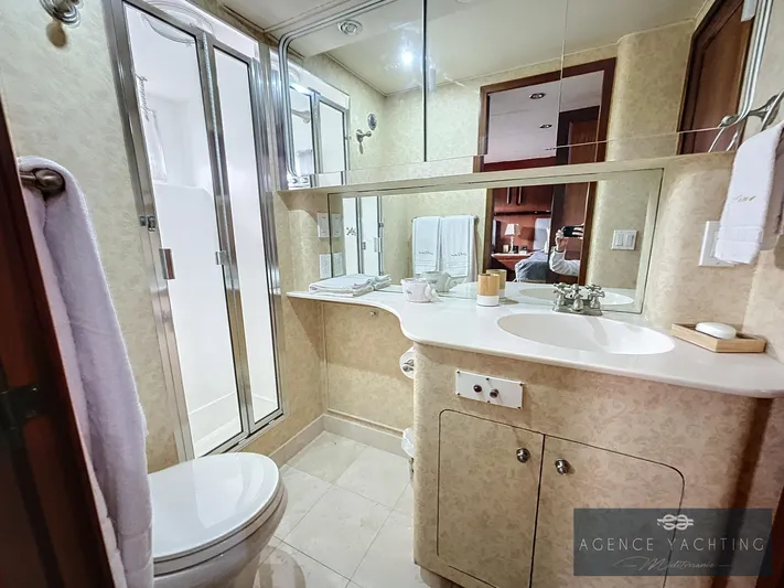  Yacht Photos Pics Luxurious bathroom in a 1987 Hatteras 85 yacht with modern fixtures and elegant design.