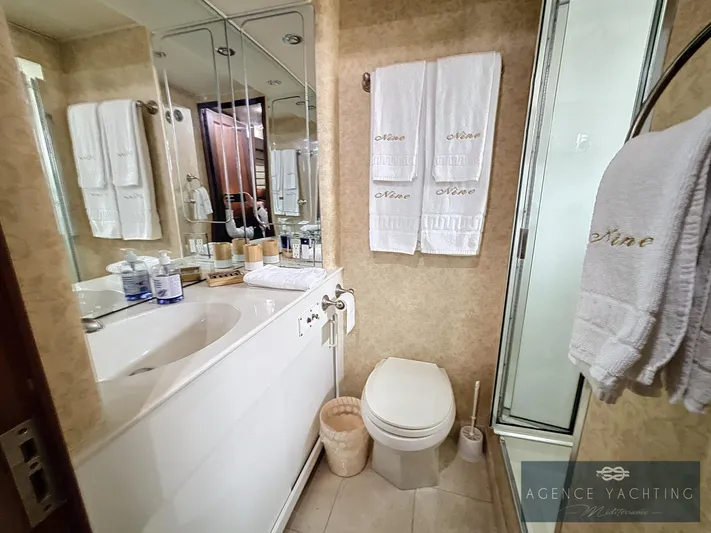  Yacht Photos Pics Luxurious bathroom on 1987 Hatteras 85 yacht with elegant fixtures and towels.