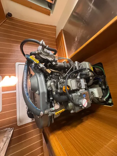 Sea-ductive Yacht Photos Pics Engine of a 2011 Catalina 375 sailboat, showcasing detailed components and wooden interior.