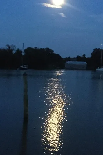 Sea-ductive Yacht Photos Pics Moonlit night over calm waters with Catalina 375 sailboat, 2011 model, in the distance.