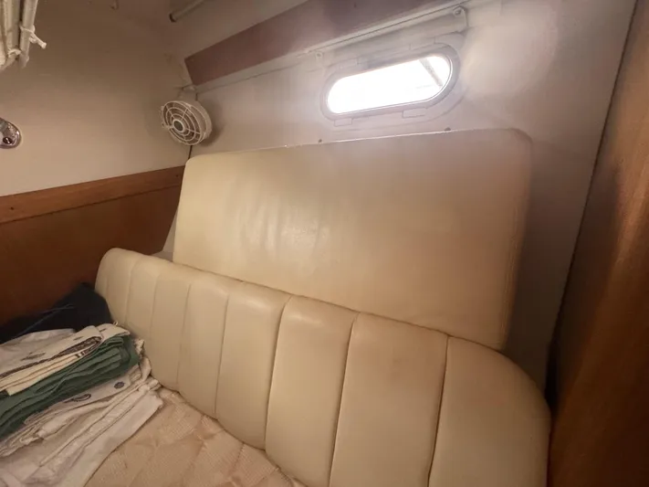 Sea-ductive Yacht Photos Pics Interior cabin of a 2011 Catalina 375 sailboat with beige cushions and window.