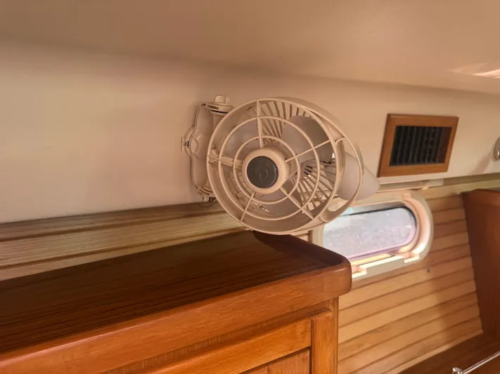 Sea-ductive Yacht Photos Pics Interior of 2011 Catalina 375 sailboat with wall-mounted fan and wooden cabinetry.
