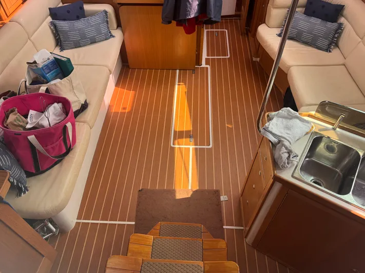 Sea-ductive Yacht Photos Pics Interior of a 2011 Catalina 375 sailboat with seating, sink, and wooden flooring.