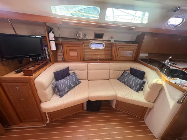 Sea-ductive Yacht Photos Pics Interior of 2011 Catalina 375 yacht with cozy seating and wooden cabinetry.