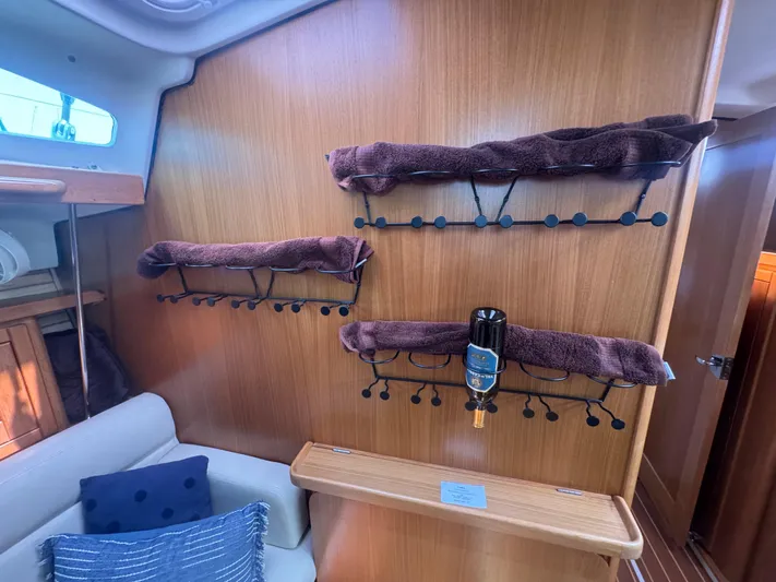 Sea-ductive Yacht Photos Pics Interior of 2011 Catalina 375 yacht with wooden wall and cushioned seating.