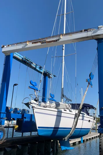 Sea-ductive Yacht Photos Pics 2011 Catalina 375 sailboat in dry dock, supported by a blue crane.
