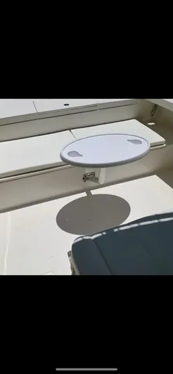  Yacht Photos Pics 2020 Calcutta 263 Center Console boat interior with a small round table and seating area.