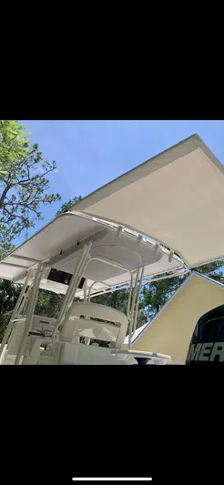  Yacht Photos Pics 2020 Calcutta 263 Center Console boat with T-top, viewed from below against a clear sky.