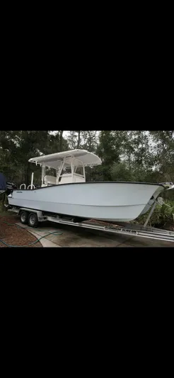  Yacht Photos Pics 2020 Calcutta 263 Center Console boat on trailer, parked outdoors.