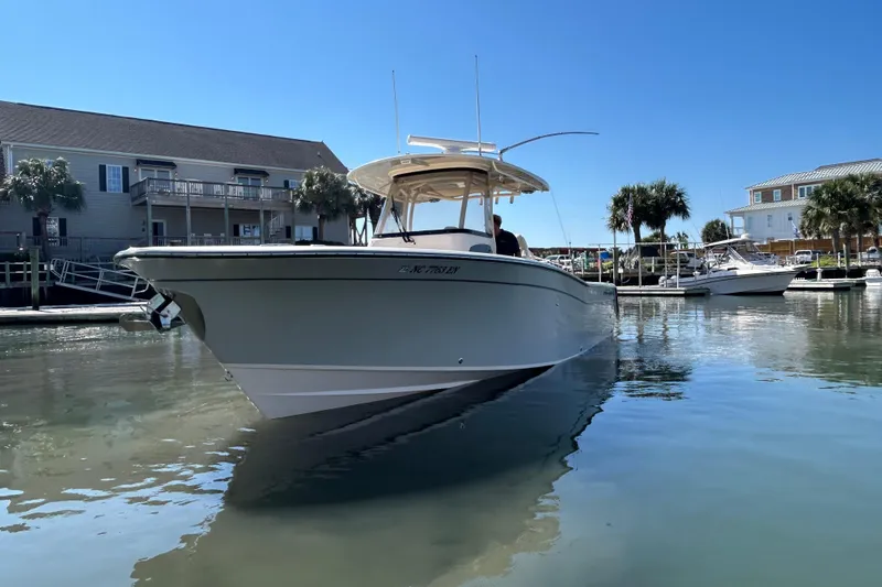  Yacht Photos Pics 2020 Grady-White Canyon 306 boat docked in a sunny marina setting.