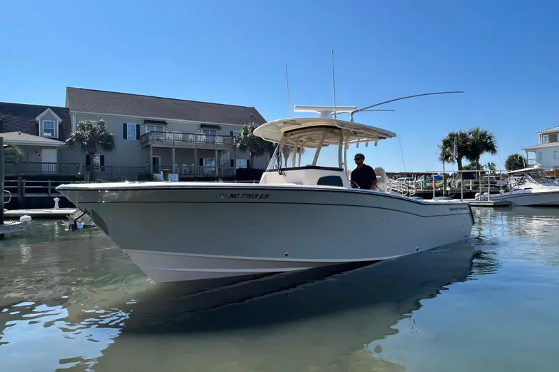 Yacht Photos Pics 2020 Grady-White Canyon 306 boat docked in a sunny marina setting.