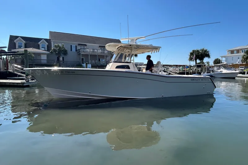  Yacht Photos Pics 2020 Grady-White Canyon 306 boat docked in a marina under clear blue skies.