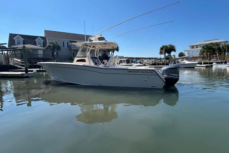  Yacht Photos Pics 2020 Grady-White Canyon 306 boat docked in a marina under clear blue skies.