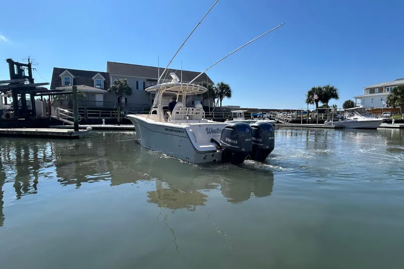  Yacht Photos Pics 2020 Grady-White Canyon 306 boat docked in a sunny marina setting.