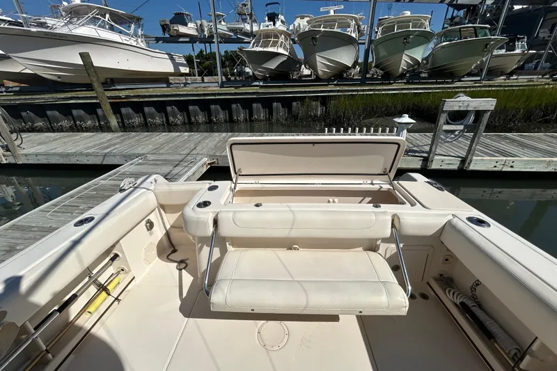  Yacht Photos Pics 2020 Grady-White Canyon 306 boat interior with open storage, docked near other boats.