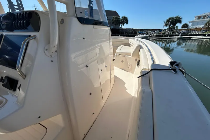  Yacht Photos Pics 2020 Grady-White Canyon 306 boat interior, docked in a marina under clear blue skies.
