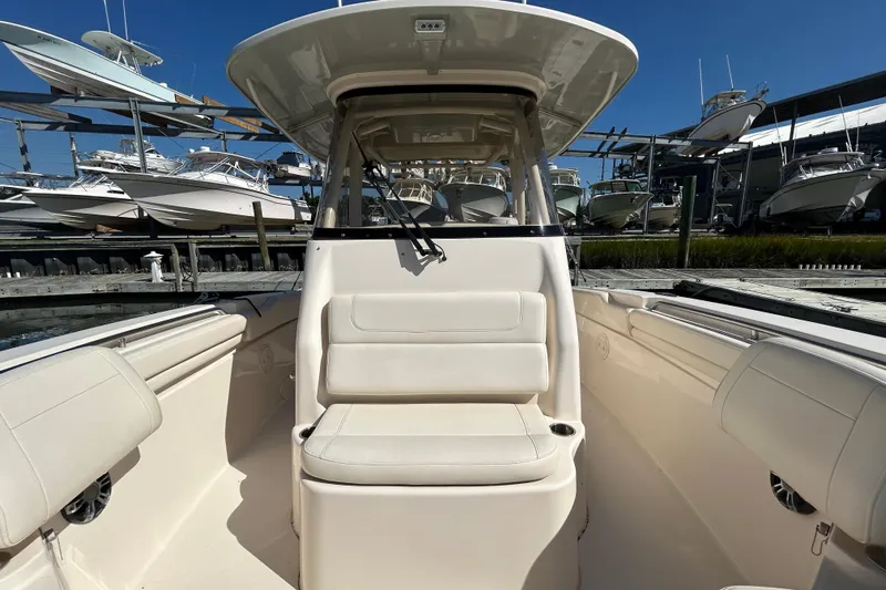  Yacht Photos Pics 2020 Grady-White Canyon 306 boat interior with seating, docked among other boats.