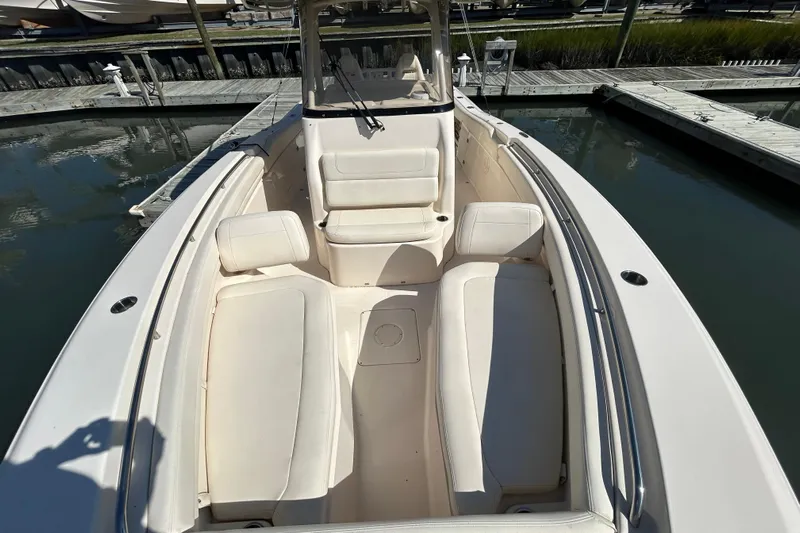  Yacht Photos Pics 2020 Grady-White Canyon 306 boat interior with cushioned seating at dock.