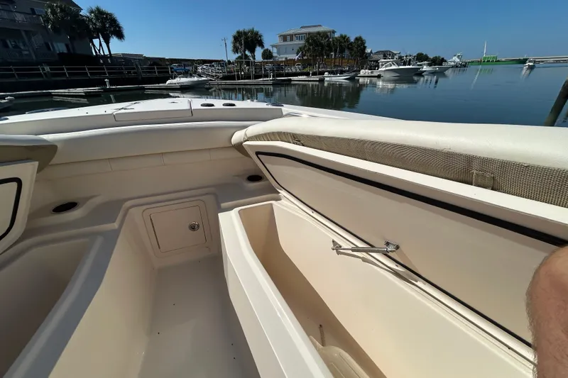  Yacht Photos Pics 2020 Grady-White Canyon 306 boat interior with open storage, docked in a marina.