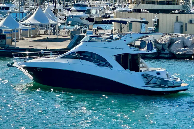 Motomar 1 Yacht Photos Pics 2008 Sea Ray 500 Sedan Bridge yacht docked in a sunny marina.