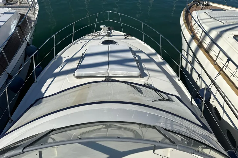 Motomar 1 Yacht Photos Pics 2008 Sea Ray 500 Sedan Bridge yacht docked between two boats.