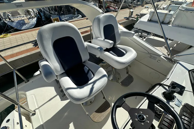 Motomar 1 Yacht Photos Pics Captain's chairs on 2008 Sea Ray 500 Sedan Bridge yacht, docked at marina.