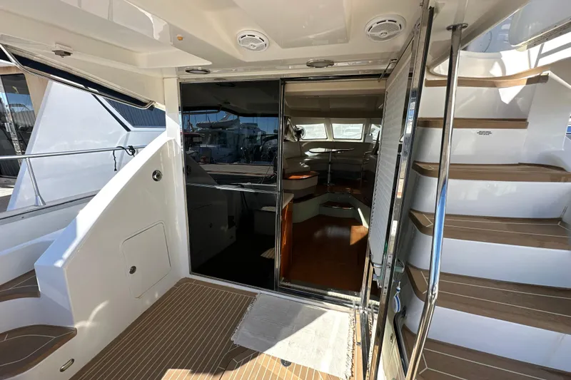 Motomar 1 Yacht Photos Pics 2008 Sea Ray 500 Sedan Bridge yacht interior with wooden stairs and glass doors.