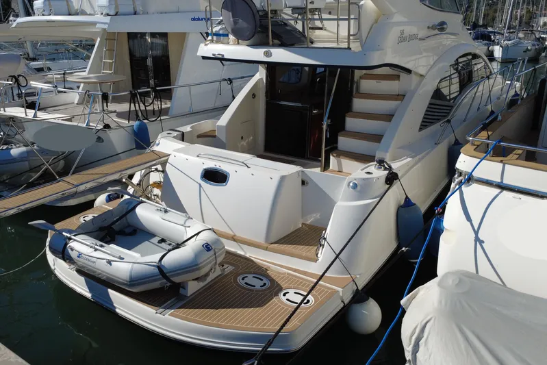 Motomar 1 Yacht Photos Pics 2008 Sea Ray 500 Sedan Bridge yacht docked with inflatable boat on deck.