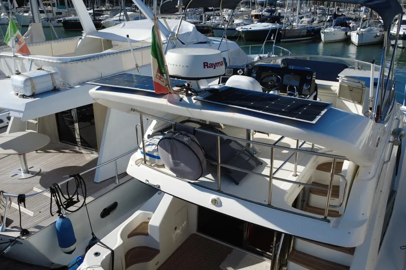 Motomar 1 Yacht Photos Pics 2008 Sea Ray 500 Sedan Bridge yacht docked, featuring solar panels and spacious deck.