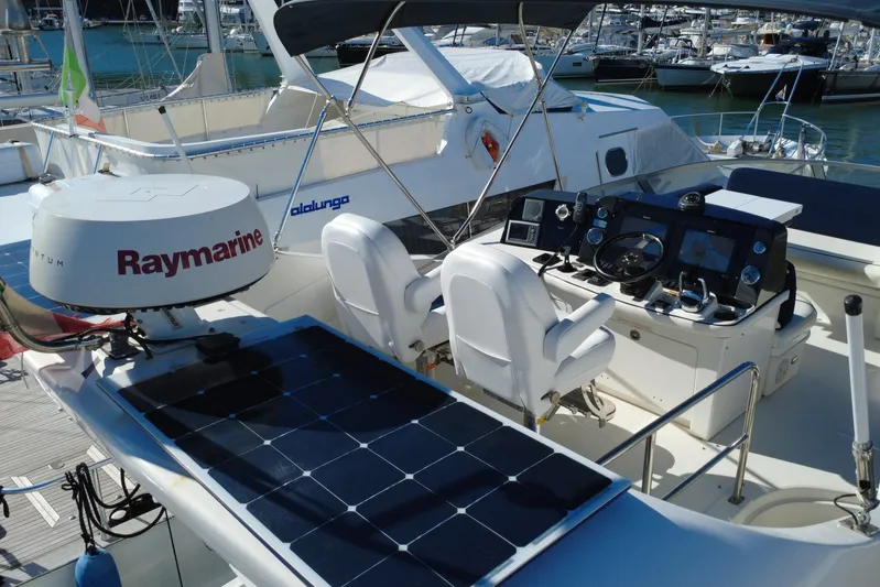 Motomar 1 Yacht Photos Pics 2008 Sea Ray 500 Sedan Bridge yacht helm with Raymarine equipment and solar panels.