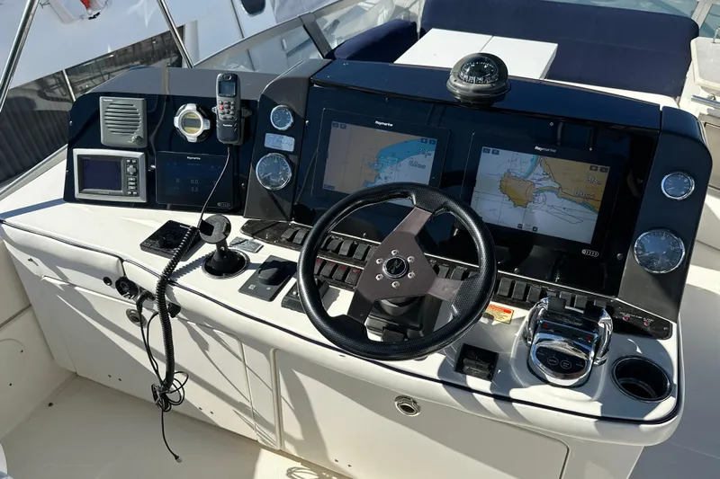 Motomar 1 Yacht Photos Pics 2008 Sea Ray 500 Sedan Bridge helm with navigation screens and controls.