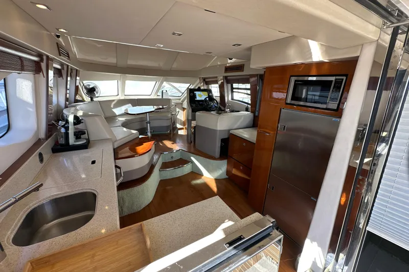 Motomar 1 Yacht Photos Pics Luxurious interior of 2008 Sea Ray 500 Sedan Bridge yacht with modern kitchen and seating area.