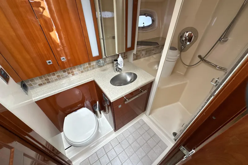 Motomar 1 Yacht Photos Pics Luxurious 2008 Sea Ray 500 Sedan Bridge bathroom with modern fixtures and elegant wood cabinetry.