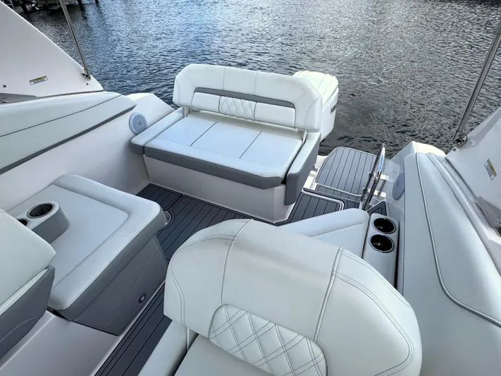  Yacht Photos Pics Luxurious seating on 2024 Regal 26 XO boat with water view.
