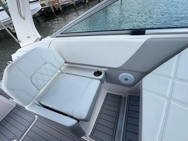 Yacht Photos Pics 2024 Regal 26 XO boat interior with white seating and cup holder by the water.